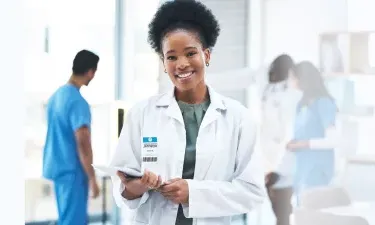 Washington DC DNP nurse executive smiling with patient charts in hospital