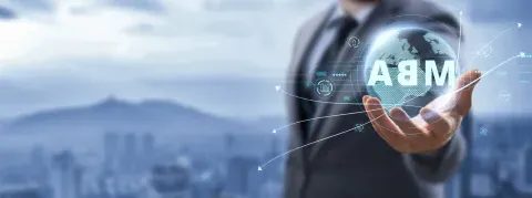 Man in a suit holding globe with MBA superimposed on top